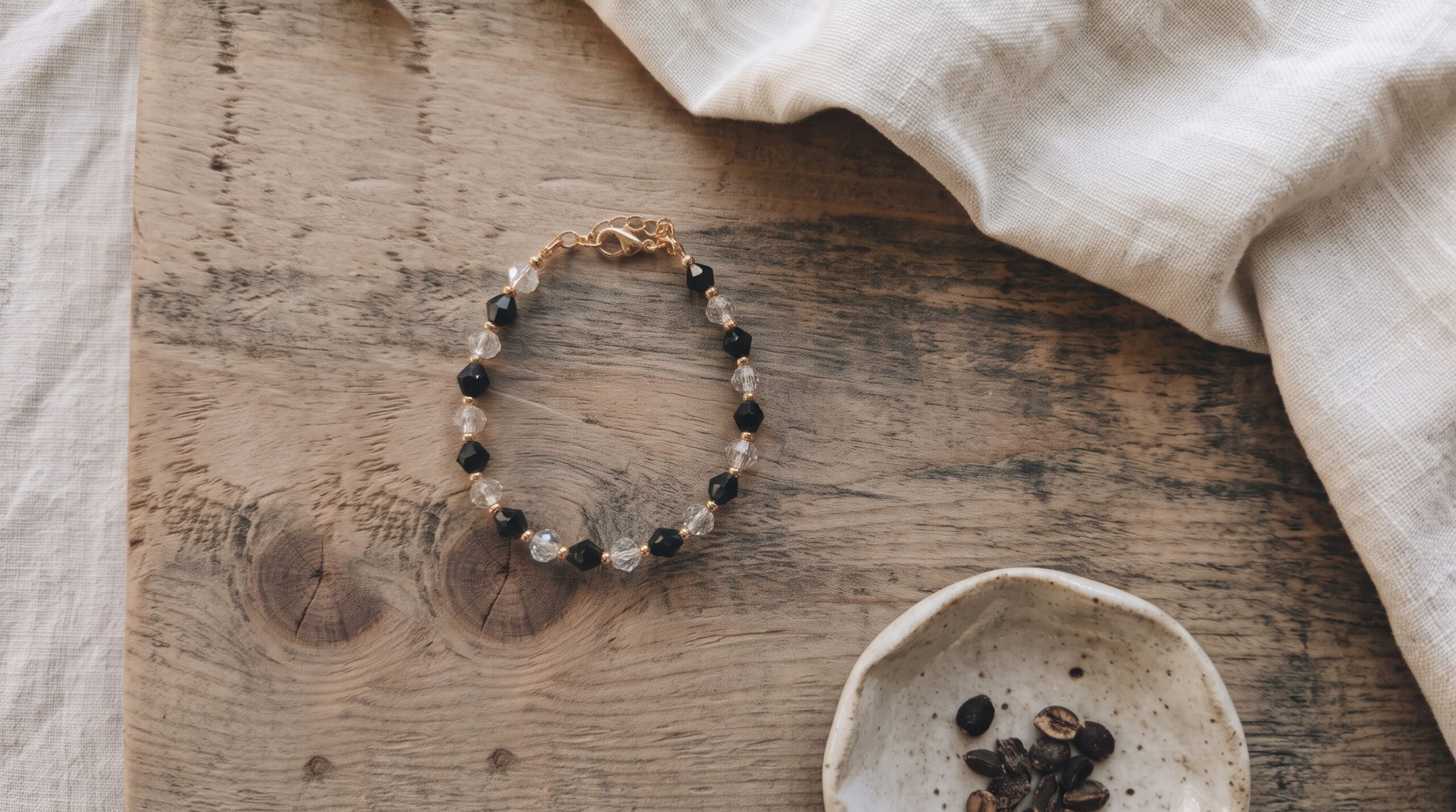 Nora bracelet with black and transparent crystals and gold spacer beads